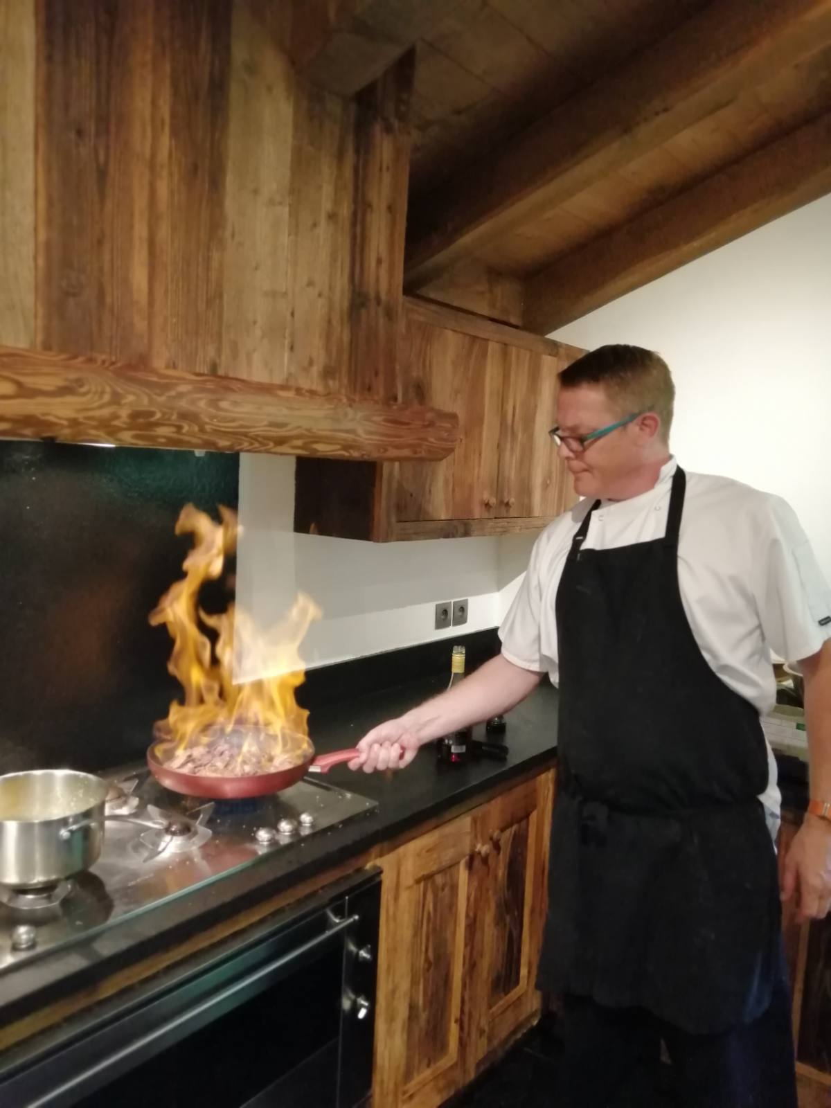 James flambéing at the stove